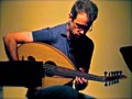 Brian Prunka playing oud in New Orleans